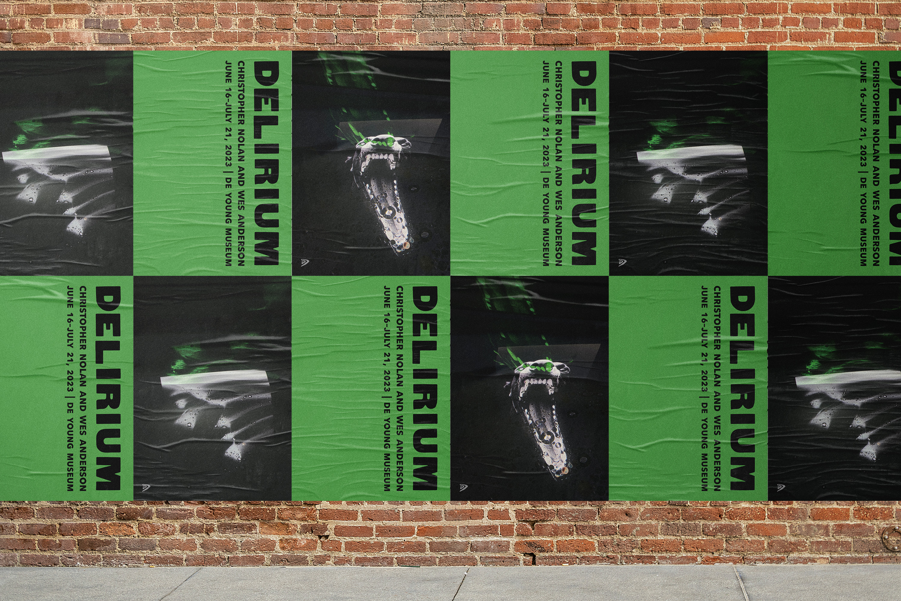 A brick wall with black and green posters pasted up in a tiled, alternating way.