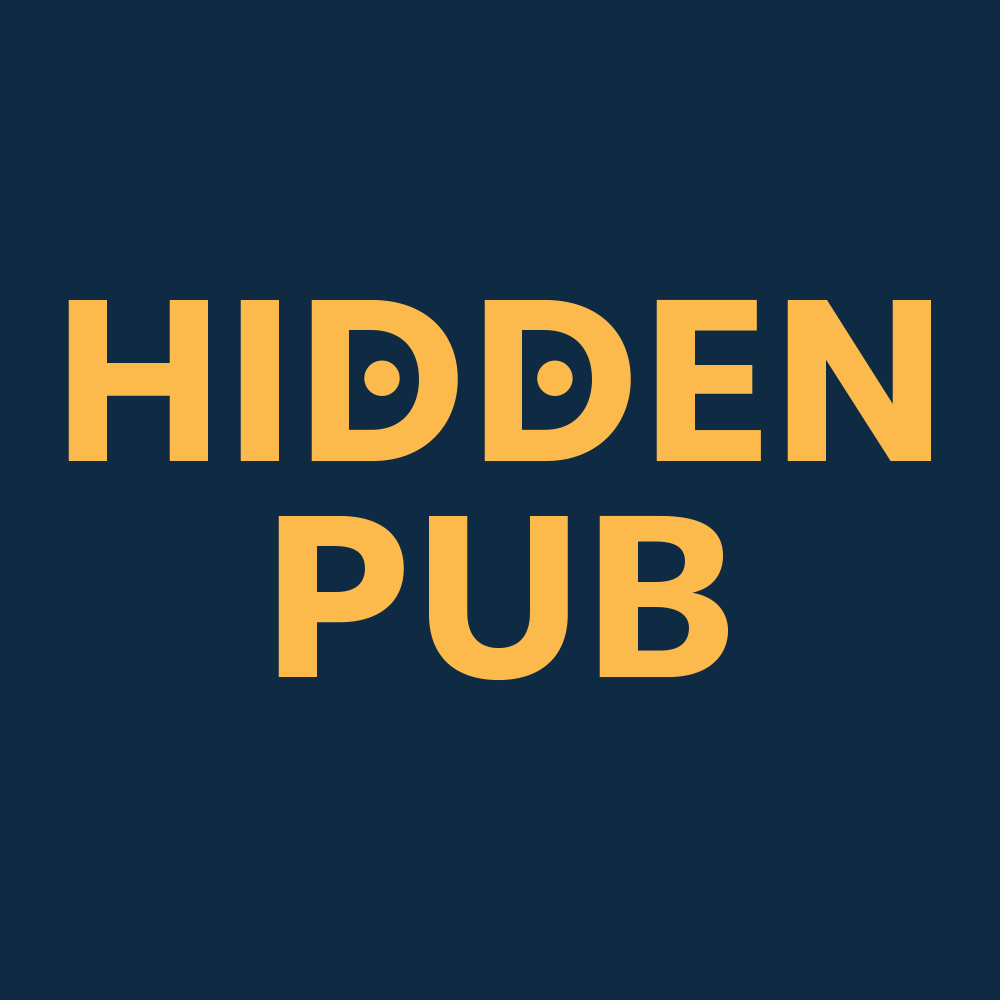 A brick wall with black and green posters pasted up in a tiled, alternating way.